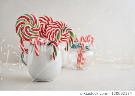 Christmas candy canes, lollipops and marshmallows in a mug Christmas candy canes, lollipops and marshmallows in a mug 120692154