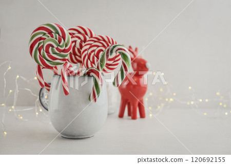 Christmas candy canes, lollipops and marshmallows in a mug Christmas candy canes, lollipops and marshmallows in a mug 120692155