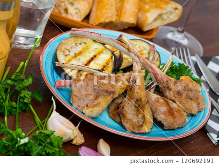 Lamb ribs with aubergine and herbs 120692191