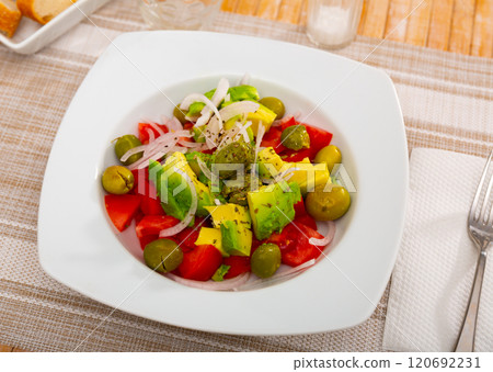 Fresh salad with avocado, tomato, olives and onion 120692231
