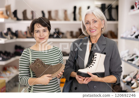 Two women are shopping in shoe store 120692246