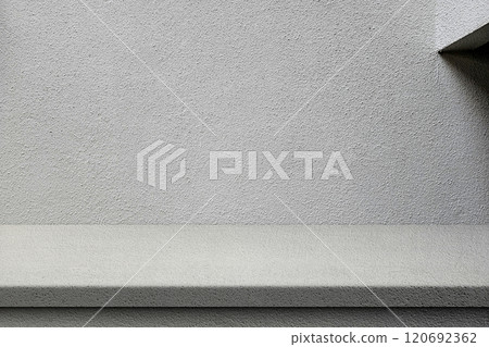 Grey Stucco Table and Wall with Natural Light and and Minimal Beam on Right, Suitable for Product Presentation Backdrop, Display, and Mock up. Grey Stucco Table and Wall with Natural Light and and Minimal Beam on Right, Suitable for Product Presentation Backdrop, Display, and Mock up. 120692362