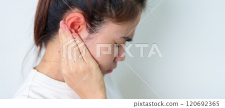 Woman holding her painful Ear. Ear disease, Atresia, Otitis Media, Inflation, Pertorated Eardrum, Meniere syndrome, otolaryngologist, Ageing Hearing Loss and Health concept Woman holding her painful Ear. Ear disease, Atresia, Otitis Media, Inflation, Pertorated Eardrum, Meniere syndrome, otolaryngologist, Ageing Hearing Loss and Health concept 120692365