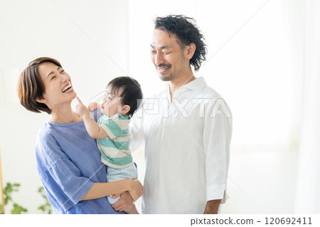 Middle-aged couple holding a baby 120692411