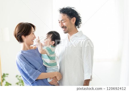 Middle-aged couple holding a baby 120692412