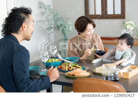 A couple feeding their baby food A couple feeding their baby food 120692427