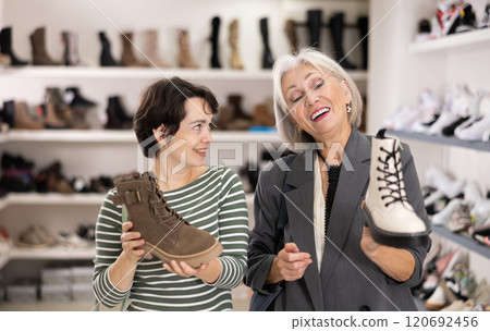 Two women are shopping in shoe store 120692456