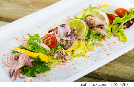 Salad with boiled squid, lime and smoked paprika Salad with boiled squid, lime and smoked paprika 120692673