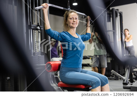 Athletic young woman works out on simulator Athletic young woman works out on simulator 120692694