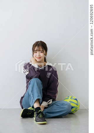 A woman in a sports mix outfit 120692695