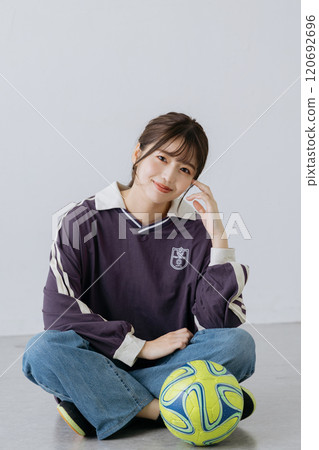 A woman wearing a soccer uniform 120692696
