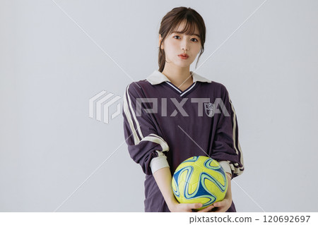 A woman with a soccer ball 120692697
