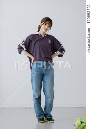 A woman in a sports mix outfit 120692701