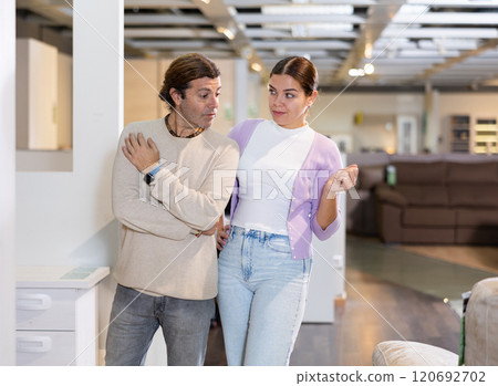 Happy couple together consider furniture store assortment 120692702