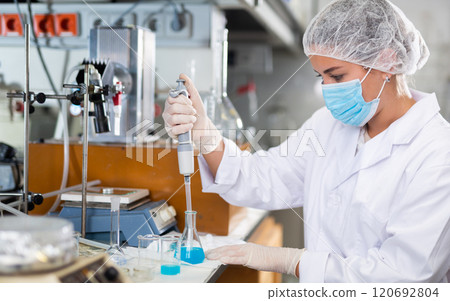 Portrait of young woman lab technician working Portrait of young woman lab technician working 120692804