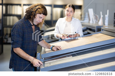 Husband and wife shopping for bathroom tiles together in hardware store Husband and wife shopping for bathroom tiles together in hardware store 120692818