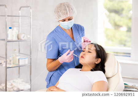 Woman getting facial beauty treatment 120692951