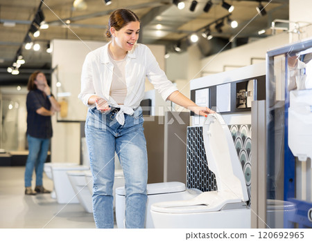 Woman choosing bathroom toilet bowl and utensils for his home 120692965