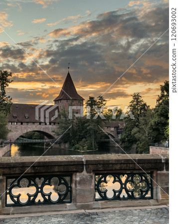 Schlayerturm medieval tower and Kettensteg (Chain Bridge) over river Pegnitz at sunset Schlayerturm medieval tower and Kettensteg (Chain Bridge) over river Pegnitz at sunset 120693002