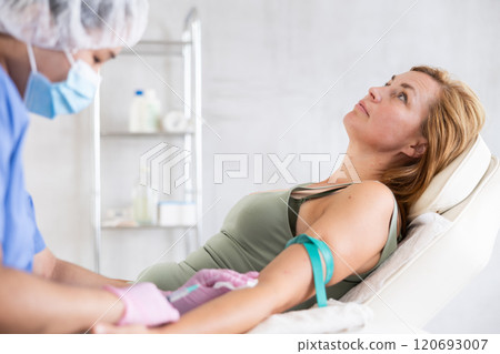young doctor giving injection into vein young doctor giving injection into vein 120693007
