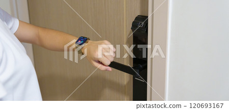 Hand using smartwatch for open digital door lock at home or apartment. NFC Technology, Fingerprint scan, keycard, PIN number, smartphone, electrical and contactless lifestyle concepts 120693167
