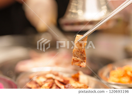 Chef Grilling meat pork on stove serve in restaurant. Korean food and BBQ traditional style Chef Grilling meat pork on stove serve in restaurant. Korean food and BBQ traditional style 120693196