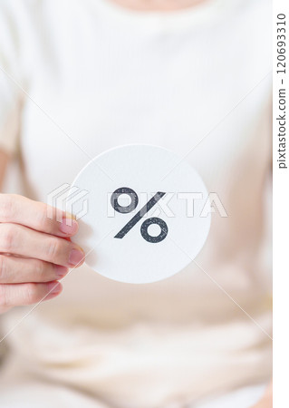 Woman show percentage symbol paper. Interest rate, financial, ranking, discount and promotion and mortgage rates concept 120693310