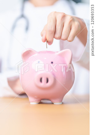 Doctor holding piggy bank and putting coin. and Healthcare cost, Money Saving, Health Insurance, Medical, Donation and Financial concepts 120693353