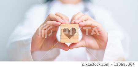 Doctor hand holding heart shape block in hospital. love, donor, world heart day, world health day, CSR donation and Insurance concepts Doctor hand holding heart shape block in hospital. love, donor, world heart day, world health day, CSR donation and Insurance concepts 120693364