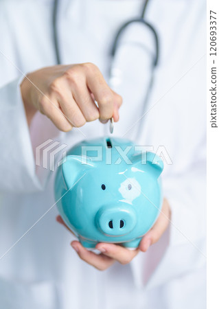 Doctor holding piggy bank and putting coin. and Healthcare cost, Money Saving, Health Insurance, Medical, Donation and Financial concepts 120693377