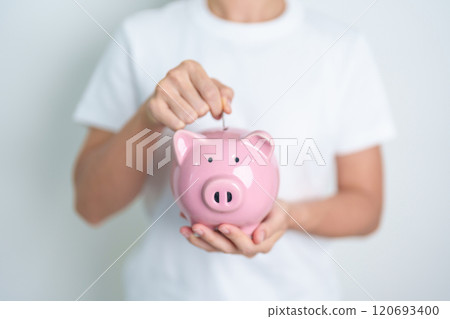 Money Saving for Future Plan, Retirement fund, Pension, Investment, Wealth Business and Financial concepts. hand holding and putting into piggy bank, Money Counting for World Savings day and Donate 120693400