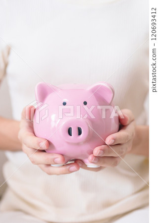 Money Saving for Future Plan, Retirement fund, Pension, Investment, Wealth Business and Financial concepts. hand holding and putting into piggy bank, Money Counting for World Savings day and Donate 120693412