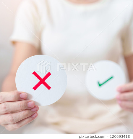 Woman show Wrong symbol paper. True and false, accept and rejected, evaluation, Vote, Poll, Yes or No and Survey concepts Woman show Wrong symbol paper. True and false, accept and rejected, evaluation, Vote, Poll, Yes or No and Survey concepts 120693418