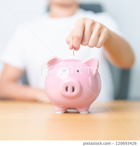 Money Saving for Future Plan, Retirement fund, Pension, Investment, Wealth Business and Financial concepts. hand holding and putting into piggy bank, Money Counting for World Savings day and Donate Money Saving for Future Plan, Retirement fund, Pension, Investment, Wealth Business and Financial concepts. hand holding and putting into piggy bank, Money Counting for World Savings day and Donate 120693426