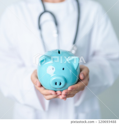 Doctor holding piggy bank and putting coin. and Healthcare cost, Money Saving, Health Insurance, Medical, Donation and Financial concepts 120693488