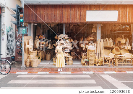 Young asian woman traveler in dress with hat traveling to wicker shop on Chang Moi Kao Road, Tourist visit at the old city in Chang Mai, Thailand. Asia Travel, Vacation and summer holiday concept Young asian woman traveler in dress with hat traveling to wicker shop on Chang Moi Kao Road, Tourist visit at the old city in Chang Mai, Thailand. Asia Travel, Vacation and summer holiday concept 120693628