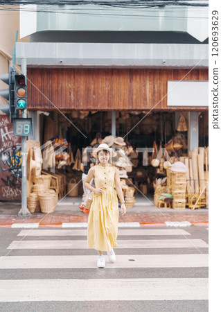 Young asian woman traveler in dress with hat traveling to wicker shop on Chang Moi Kao Road, Tourist visit at the old city in Chang Mai, Thailand. Asia Travel, Vacation and summer holiday concept Young asian woman traveler in dress with hat traveling to wicker shop on Chang Moi Kao Road, Tourist visit at the old city in Chang Mai, Thailand. Asia Travel, Vacation and summer holiday concept 120693629