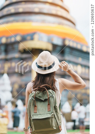 Young asian woman traveler in white dress with hat and bag traveling in Wat Phra That Lampang Luang, Tourist visit at Lampang, Thailand.. Asia Travel, Vacation and summer holiday concept 120693637