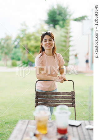 Happy woman with Dessert in cafe, young Asian girl smiling during eating cake and drinking ice beverage at home Happy woman with Dessert in cafe, young Asian girl smiling during eating cake and drinking ice beverage at home 120693649