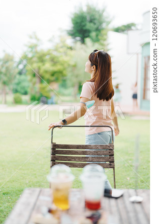 Happy woman with Dessert in cafe, young Asian girl smiling during eating cake and drinking ice beverage at home 120693650