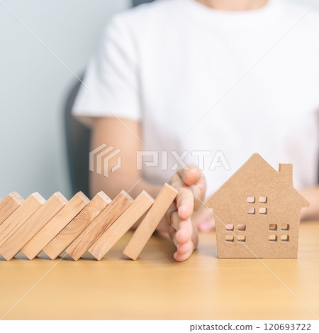 hand stop falling wood blocks and protect house model. Crisis, fall Business, Risk, Economic recession, Developer, Real Estate and Property concept hand stop falling wood blocks and protect house model. Crisis, fall Business, Risk, Economic recession, Developer, Real Estate and Property concept 120693722