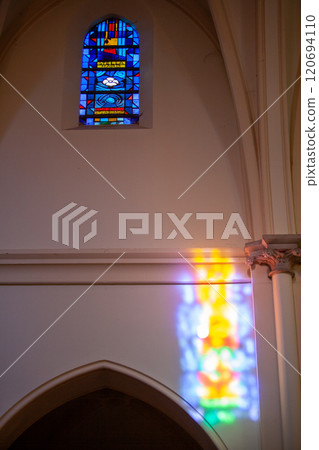 Experience the vibrant stained glass light reflection that enhances the atmosphere in the church Experience the vibrant stained glass light reflection that enhances the atmosphere in the church 120694110