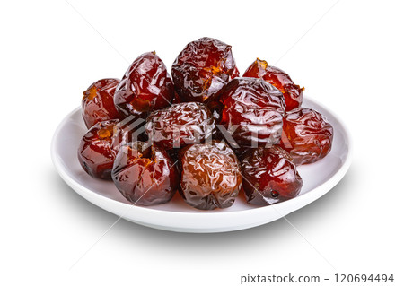 Pile of sweet pitted chinese jujube fruit preserved in syrup in white ceramic dish. Pile of sweet pitted chinese jujube fruit preserved in syrup in white ceramic dish. 120694494