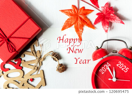 Happy New Year writing on paper note. 2024 and 2025 on red alarm clock Happy New Year writing on paper note. 2024 and 2025 on red alarm clock 120695475