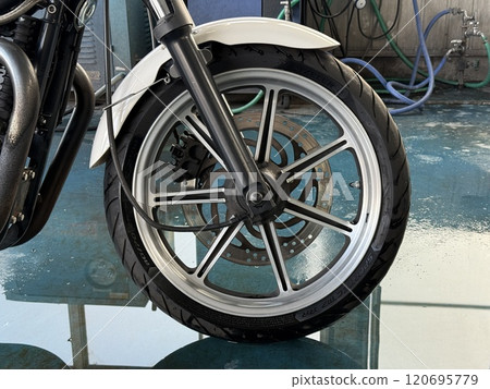 A washed motorcycle front wheel 120695779