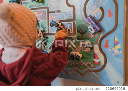Toddler playing with wooden educational toys Toddler playing with wooden educational toys 120696026