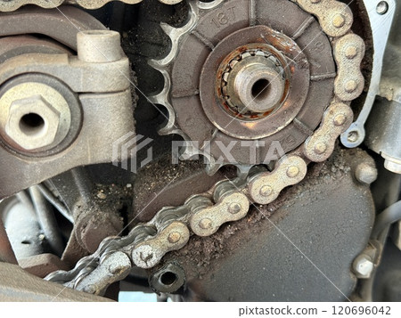 Old chain and sprockets on a motorcycle 120696042