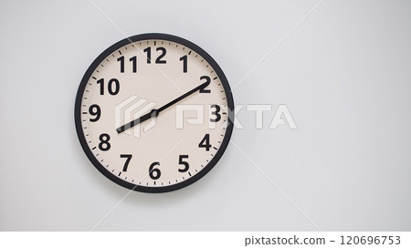 Classic Black-Edged Clock on White Background at 20.10/08.10 - Perfect for Time Management and Text Space 120696753
