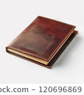 Vintage leather-bound journal with worn pages on white surface antique writing concept 120696869