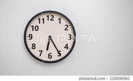 Classic Black-Edged Clock on White Background at 18.25/06.25 - Perfect for Time Management and Text Space 120696982
